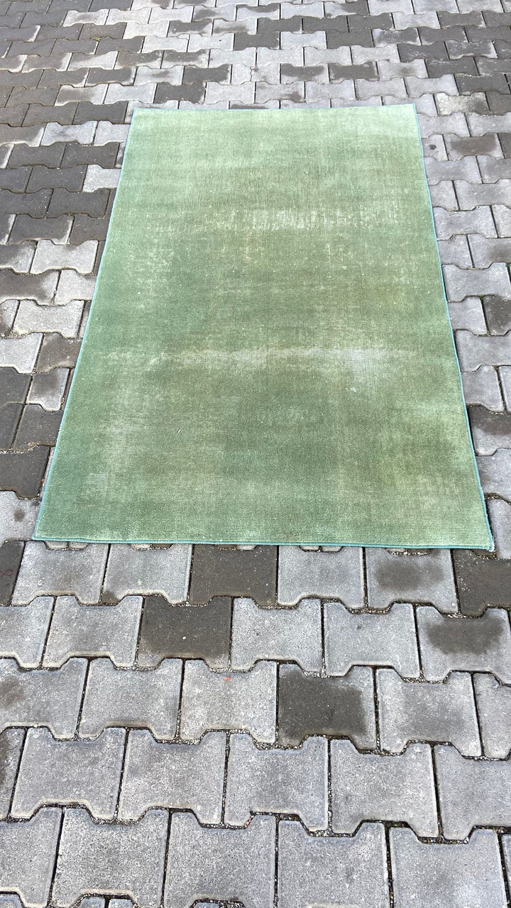 Green vintage handmade carpet