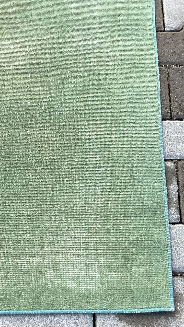 Green vintage handmade carpet